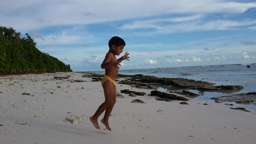 Boy jumping on beach