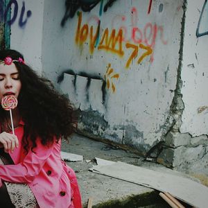 Woman with graffiti on wall