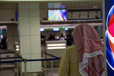 Rear view of man standing at subway station