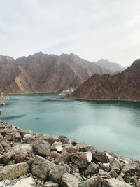 Scenic view of lake and mountains against sky. 