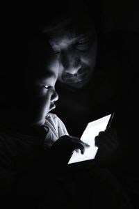 Close-up of boy holding camera