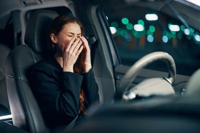 Young businesswoman crying while sitting in car