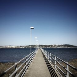 Narrow road along calm blue sea