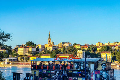 Buildings in city against clear blue sky