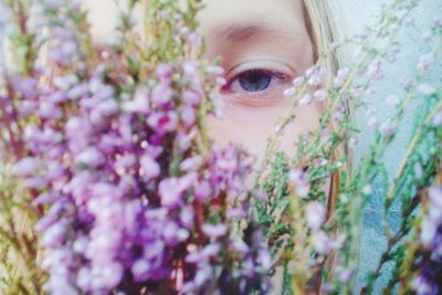 Close-up of girl behind flowers