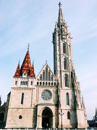 Low angle view of bell tower against sky