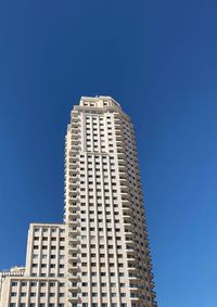 Low angle view of building against clear blue sky