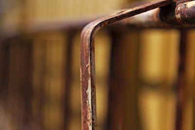 Close-up of rusty metal hanging on wood