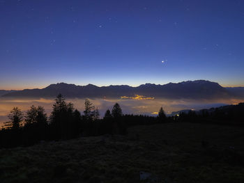 Scenic view of silhouette landscape against sky at night