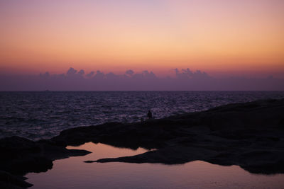 Scenic view of sea against clear sky during sunset