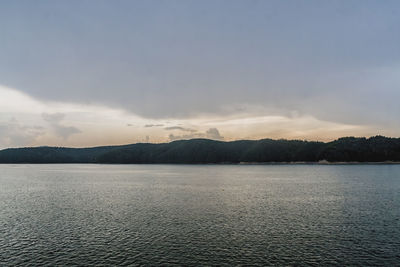 Scenic view of lake against sky during sunset