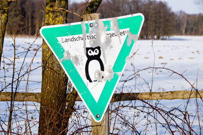 Close-up of road sign on snow