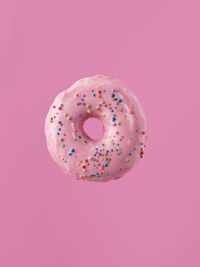 Close-up of donut against pink background