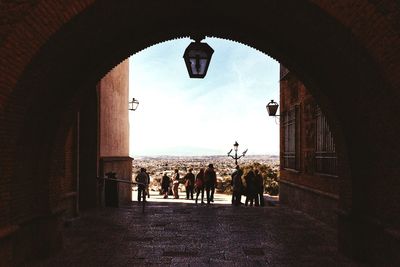 People by sea against sky