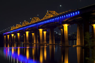 Reflection of illuminated bridge on han river at night
