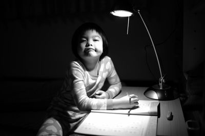 Girl studying in darkroom at home