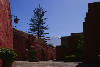 Low angle view of buildings against clear blue sky