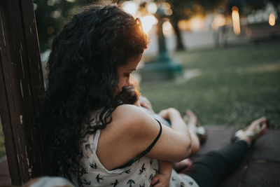 Mother embracing daughter in yard