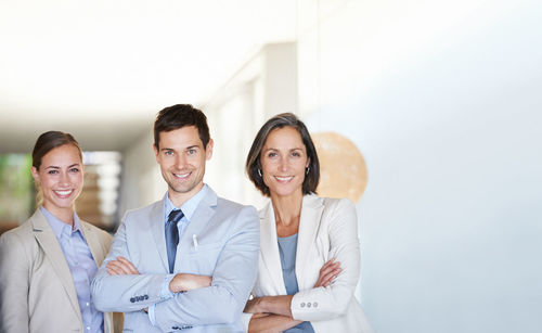 Portrait of smiling couple standing against white background