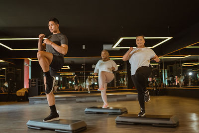 Side view of woman exercising in gym