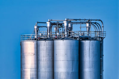 Steel tank silo against blue sky