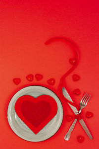 Directly above shot of heart shape on red table