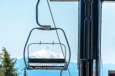 Ski lift against sky during winter