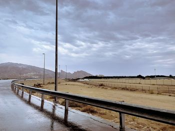 Road leading towards mountain against sky