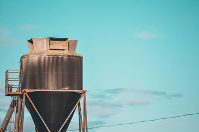 Low angle view of crane against sky