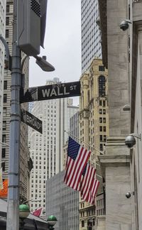 Low angle view of flag against buildings in city