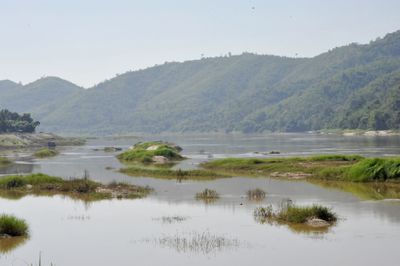 Scenic view of lake and mountains against sky