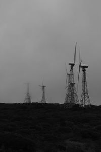 Windmill on field against sky