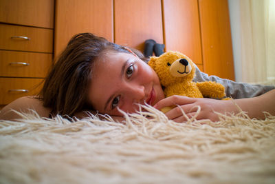 Portrait of young woman with teddy bear
