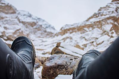 Low section of man on snowcapped mountain