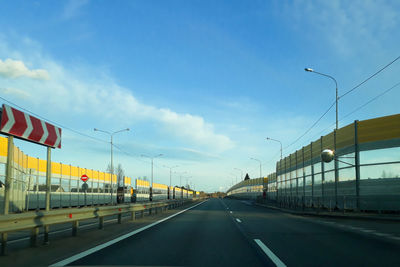 Vehicles on road against sky