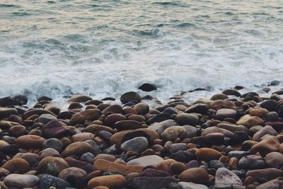 High angle view of pebbles at beach