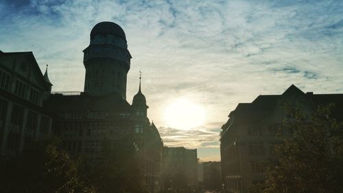 Low angle view of city against sky during sunset