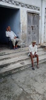 People sitting on staircase outside building