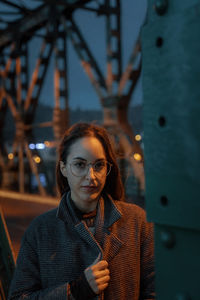 Portrait of smiling young woman on bridge