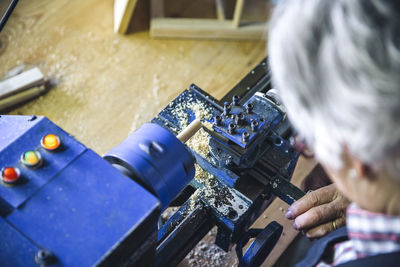 High angle view of man working on machinery