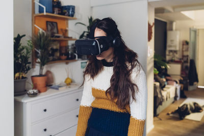 Tired woman with virtual reality headset at home