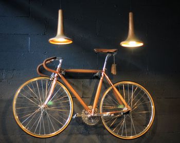 Bicycle parked against wall in city