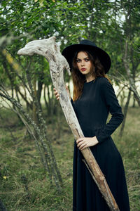 Portrait of young woman standing in forest