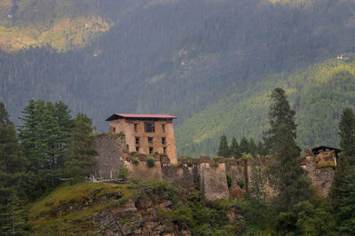 Historic building by trees on mountain