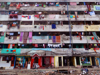 Low angle view of laundry hanging in balcony of building