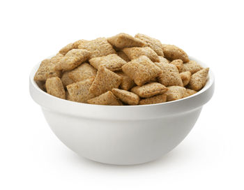Close-up of bread in bowl against white background