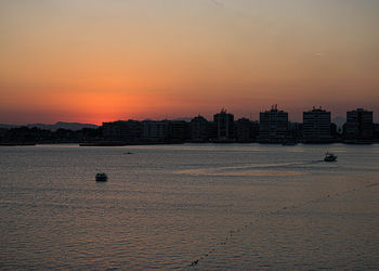 Buildings in city at sunset