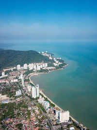 High angle view of townscape by sea against sky