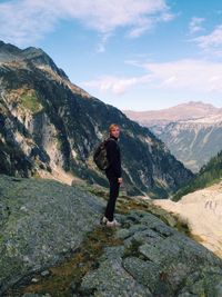 Full length of woman standing on mountain against sky