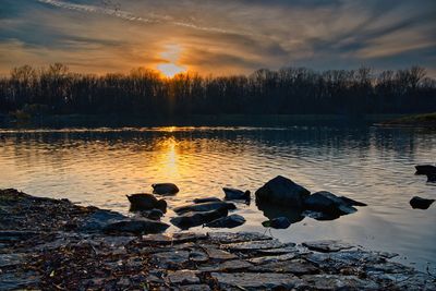 Scenic view of lake against sky during sunset